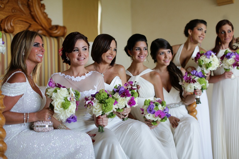 bridesmaids wearing white dresses blue green and purple bridal bouquets elena damy