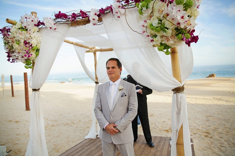 groom under chupppah tropical beach weddings elena damy