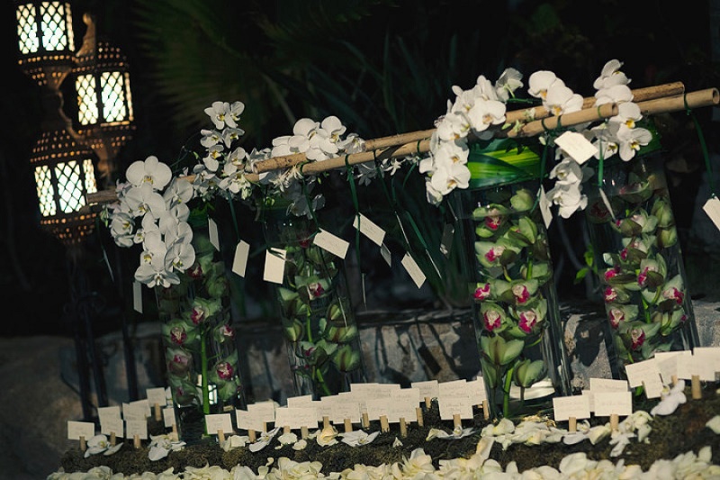 tropical place card table with orchids and floating flowers elena damy los cabos mexico