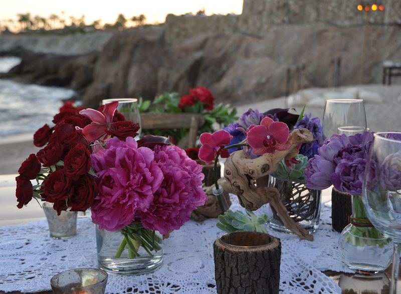 red and purple flowers beach weddings mexico elena damy floral design los cabos wooden tables lace linens 5