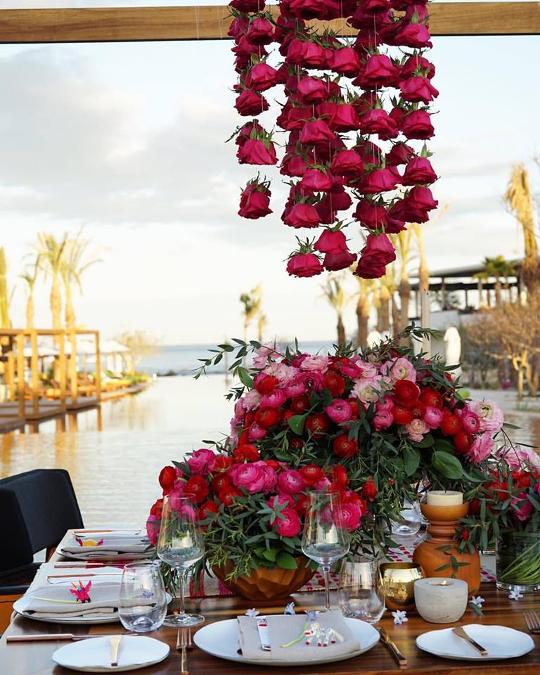 red flowers floating table chileno bay resort elena damy cabo wedding designers