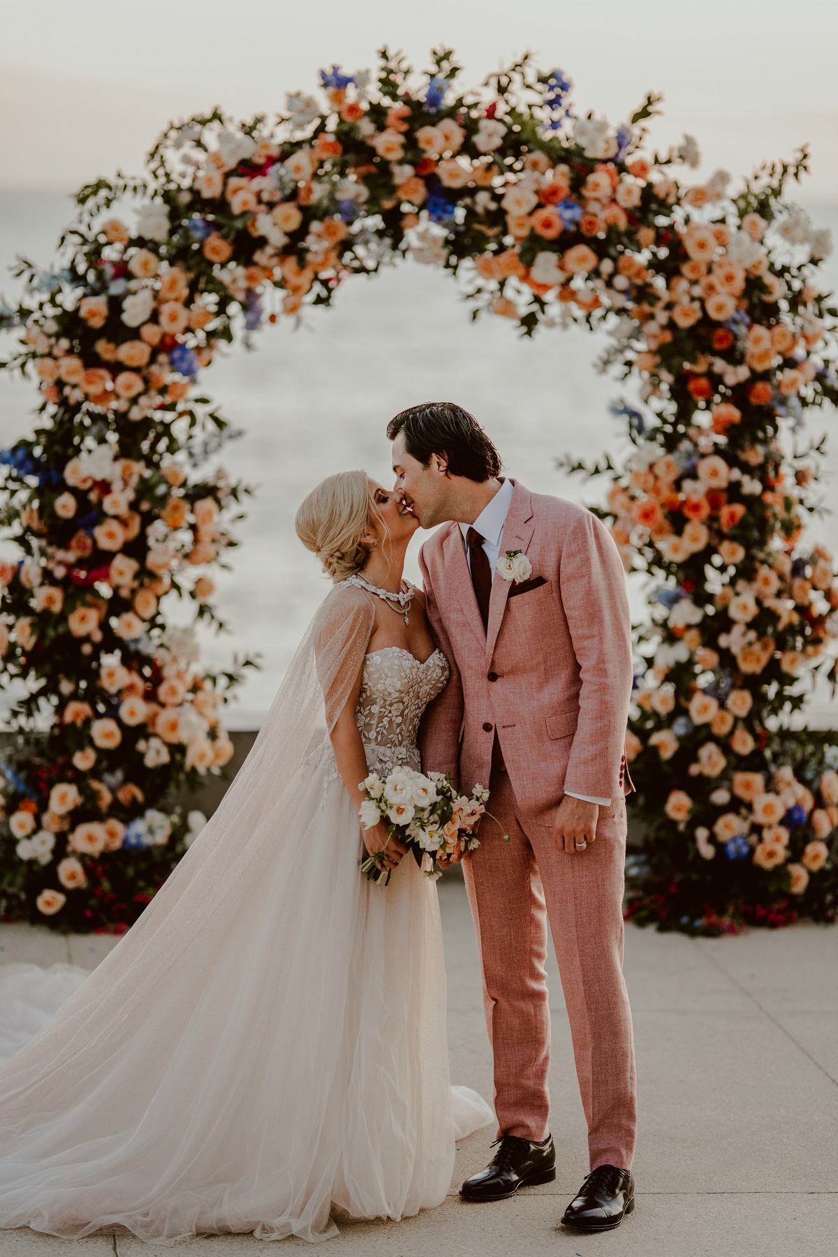 groom wearing pink suit destination weddings mexico